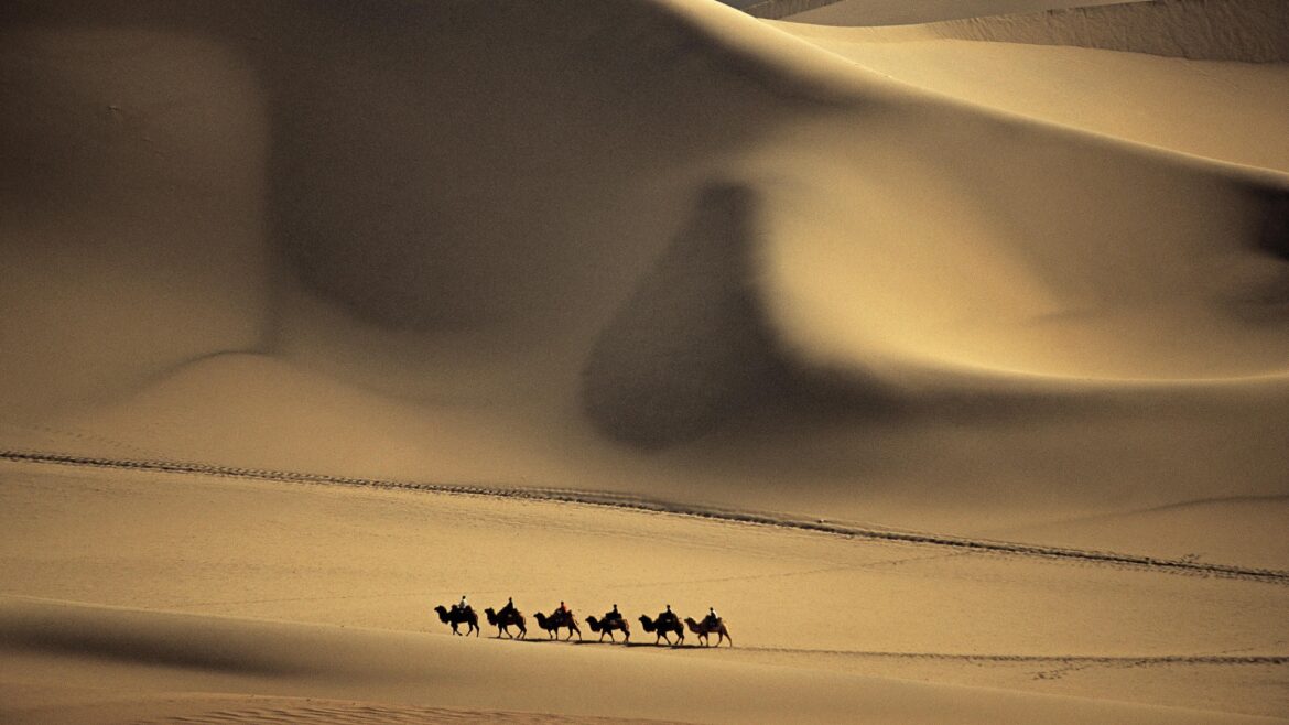 Camel_Caravan_Passes_Through_the__Sands_that_Sing___Taklimakan_Desert__China